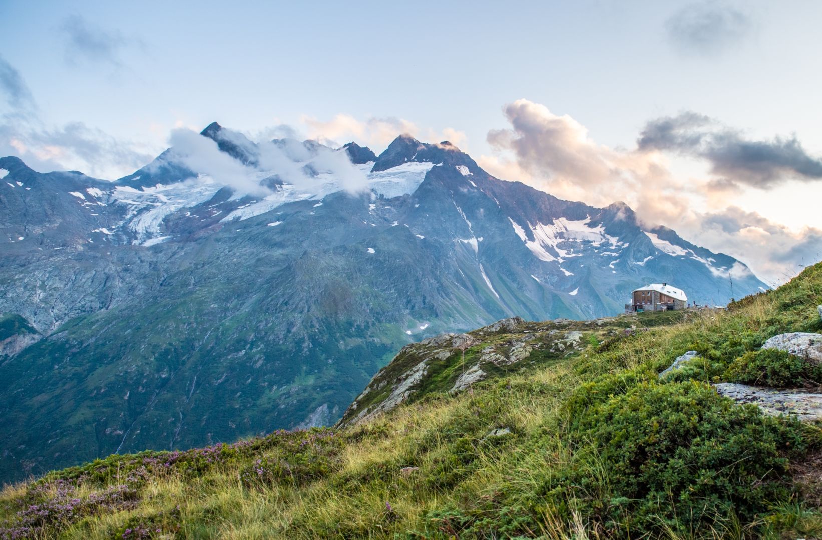 Scenic alpine mountains in summer, representing luxury travel planning for July 2026 with Somewhere Travel Co.