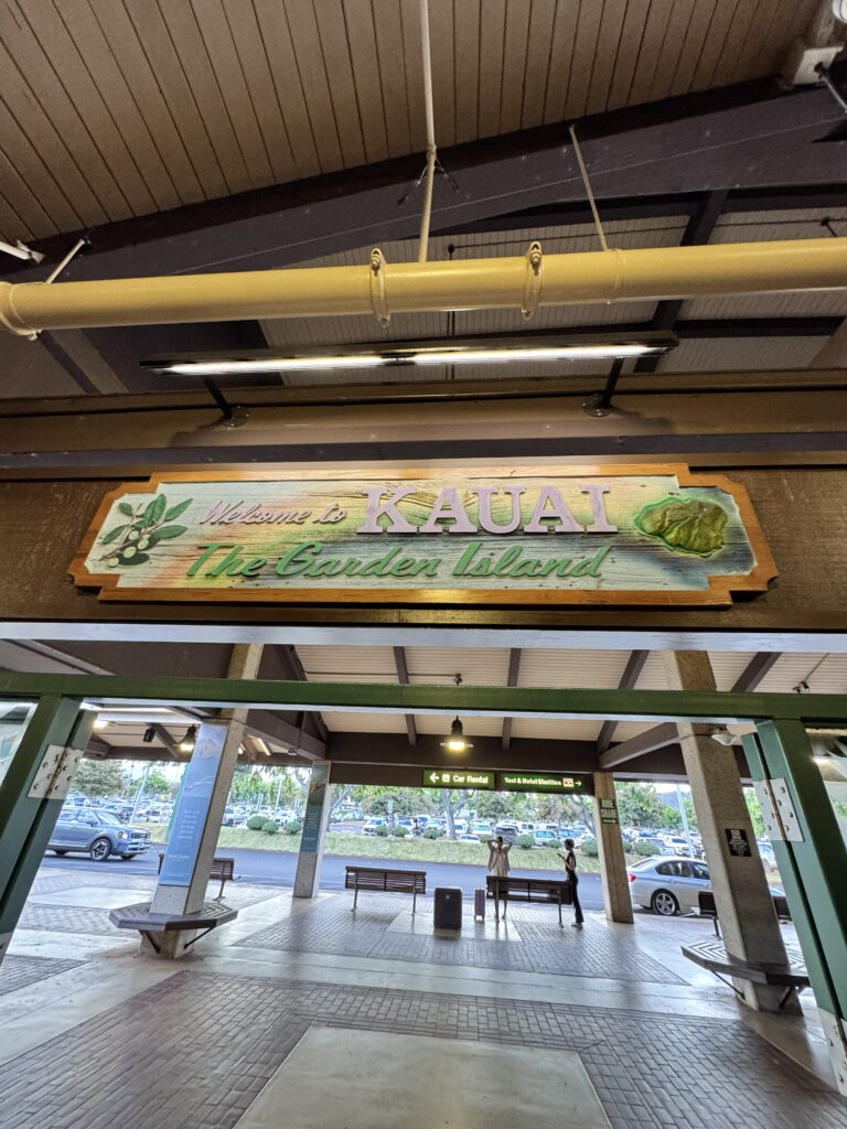 Welcome to Kauai The Garden Island sign at Lihue Airport