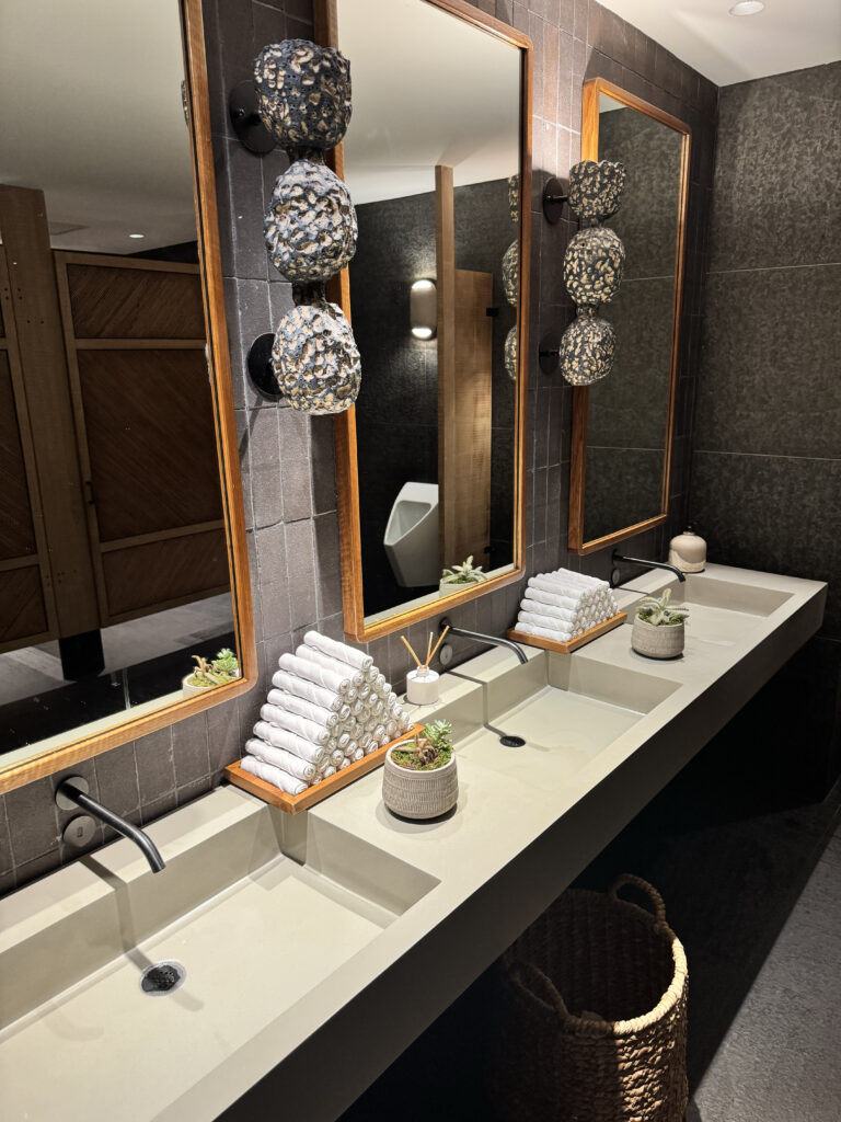 Modern bathroom vanity with woven light fixtures at 1 Hotel Hanalei Bay